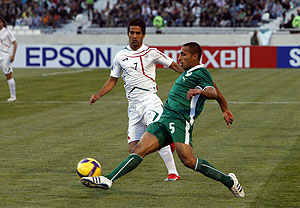 Iran's Masoud Shojaei, left, is challenged by Saudi Arabia's Mohammad Al Nakhli during their World Cup Asia group 2 qualifying soccer match at Azadi stadium, Tehran on Saturday March 28, 2009. AP Photo/Hasan Sarbakhshian
