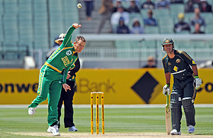 South Africa's Johan Botha bowls a delivery while Australia's Ricky Ponting looks on during their One Day International series match at the MCG in Melbourne, Friday, Jan. 16, 2009. AAP Image/Joe Castro