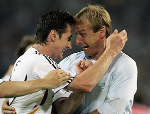 Germany coach Jurgen Klinsmann, right, celebrates with forward Miroslav Klose at the end of the World Cup, Group A soccer match between Germany and Poland, at the Dortmund stadium, Germany, Wednesday, June 14, 2006. Germany won 1-0. The other teams in Group A are Ecuador and Costa Rica. AP Photo/Murad Sezer