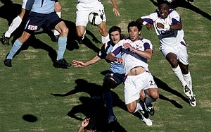 Perth's Wayne Shroj (22) and Sydney's Beau Busch go for the ball during Round 16 of the Hyundai A-League between Sydney FC and Perth Glory in Sydney, Sunday, Dec. 21, 2008. Perth won 4-1. AAP Image/Jenny Evans