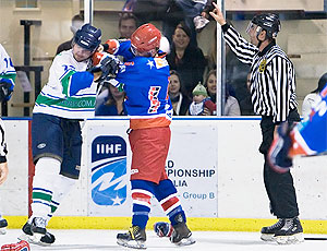 Newcastle's Ben Morrison and Gold Coast Captain Ross Howell exchange blows in an Australian Ice Hockey match. Photo by Mark Bradford