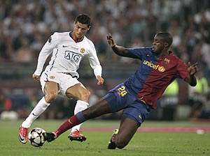 Manchester United's Cristiano Ronaldo, left, is challenged by Barcelona's Yaya Toure during the UEFA Champions League final soccer match between Manchester United and Barcelona in Rome, Wednesday May 27, 2009. AP Photo/Gregorio Borgia