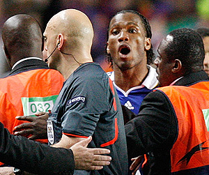 Chelsea's Didier Drogba, second from right, remonstrates at referee Tom Ovrebo as they leave the pitch following their Champions League semifinal second leg soccer match against Barcelona at Chelsea's Stamford Bridge stadium in London, Wednesday, May 6, 2009. Chelsea says it will take strong action against any fans found to have made threats against the Norwegian referee who officiated the club's Champions League semifinal against Barcelona. London's Evening Standard newspaper said Thursday that death threats have been made over the Internet against referee Tom Henning Ovrebo. AP Photo/Jon Super