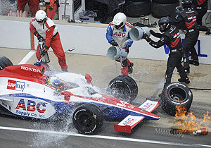 Pit crew members for Vitor Meira, of Brazil, scramble to douse flames during a pit stop in the Indianapolis 500 auto race at Indianapolis Motor Speedway in Indianapolis, Sunday, May 24, 2009. AP Photo/Chris Howell