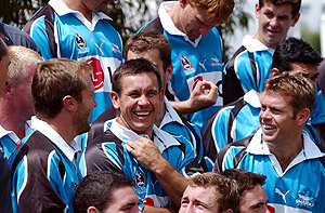 Sydney, February 20, 2002. Cronulla Sharks rugby league new recruites Matthew Johns (centre) and Brett Kimmorley (right) share a joke with Jason Stevens (left) at team training at the Sutherland Police Citizen Youth Club. AAP Image/Dean Lewins