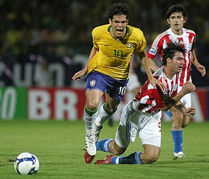 Brazil's Kaka fights for the ball with Paraguay's Julio Caceres. AP Photo/Ricardo Moraes