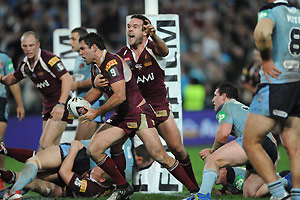 Queensland's Cameron Smith celebrates with Nate Myles. AAP Image/Dean Lewins