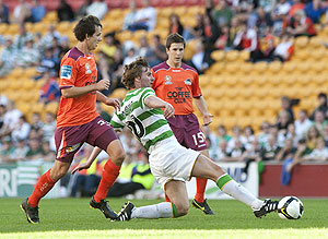 Celtic's Paddy McCourt (centre) kicks ahead during the friendly match between Scottish club Celtic and the Brisbane Roar at Suncorp Stadium in Brisbane, Sunday, July 12, 2009. Celtic defeated Brisbane 3-0. AAP Image/Dave Hunt