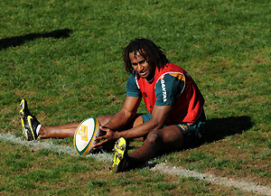Australian rugby union player Lote Tuqiri stretches at a team practice session in Sydney on Tuesday, June 23, 2009. AAP Image/Paul Miller)