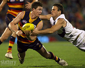 Patrick Dangerfield of the Crows tackled by Paul Hasleby of the Dockers during the AFL Round 15 match between the Adelaide Crows and the Fremantle Dockers at AAMI Stadium. The Slattery Media Group