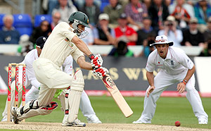 Australia's Simon Kaitch, second from left, hits a ball from England's Graeme Swann during the second day of the first cricket test match between England and Australia in Cardiff, Wales, Thursday, July 9, 2009. AP Photo/Tom Hevezi