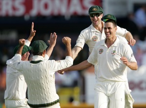 Australia's Mitchell Johnson, right, is congratulated by teammates after taking the wicket of England's Alastair Cook on the second day of the fourth cricket test match between England and Australia, at Headingley cricket ground in Leeds, England, Saturday, Aug. 8, 2009. (AP Photo/Tim Hales)