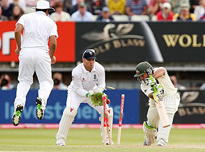 Australia's captain Ricky Ponting, right, is bowled by England's Graeme Swann as wicketkeeper Matthew Prior, centre, looks on and Ravi Bopara jumps on the fourth day of the third cricket test match between England and Australia in Birmingham, England, Sunday Aug. 2, 2009. (AP Photo/Jon Super)