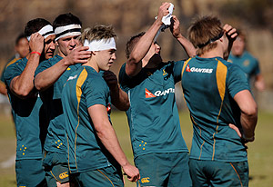 Australian rugby union backs Quade Cooper, Adam Ashley-Cooper, James O'Connor, Matt Giteau and Drew Mitchell remove the tape they used to prepare themselves to take on the forwards during a practice session in Sydney on Thursday, July 23, 2009. The Wallabies next match will be against South Africa in Cape Town on August 8. AAP Image/Paul Miller