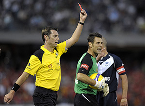 The referee holds up a red card to send Christiano of Adelaide United from the field at the Grand Final of the A League Soccer at the Telstradome in Melbourne, Saturday, Feb. 28, 2009. AAP Image/Martin Philbey