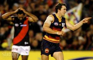 Jason Porplyzia of Adelaide celebrates while Nathan Lovett-Murray of Essendon looks on during the AFL 1st Elimination Final between the Adelaide Crows and the Essendon Bombers at AAMI Stadium.