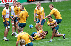 Australian Wallabies halfback Will Genia (bottom right) passes the ball during the team training session in Brisbane, Friday, Sept. 4, 2009. The Wallabies play South Africa in their Tri-Nations match at Suncorp Stadium tomorrow. AAP Image/Dave Hunt