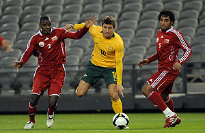 Harry Kewell of Australia is challenged by Mohammed Addullah of Oman and team-mate Mohamed Rabia Jamaan Al Noobi during a FIFA Asian Cup qualifying match, played at Docklands Stadium in Melbourne, Wednesday, Oct. 14, 2009. Australia is leading 1-0 deep into the second half. AAP Image/Joe Castro