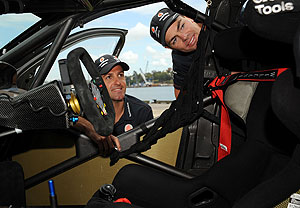 Jamie Whincup (left) and Craig Lowndes pose with a team Ford Falcon in Sydney on Monday, Oct. 6, 2009. AAP Image/Paul Miller