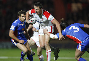 England's Sam Burgess, centre, is tackled by France's Sebastien Raguin, right, during their Four Nations rugby league match at the Keepmoat Stadium, Doncaster, England, Friday Oct. 23, 2009. AP Photo/Jon Super