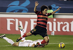 South Korea's Pohang Steelers's Song Chang-ho, right, is tackled by Qatar's Umm Salal's Ben Askar during an AFC League Semi Final first leg soccer match in Pohang, South Korea, Wednesday, Oct. 21, 2009. AP Photo/Yonhap, Lee Sung-hyong