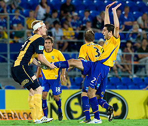 Gold Coast's Steve Pantelidis (right) raises his arms