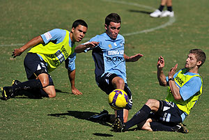 Sydney FC players Stuart Musialik and Shannon Cole take part in a team training session as Ian Ramsey looks on in Sydney. AAP Image/Paul Miller