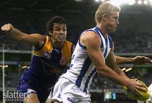 Liam Anthony of North Melbourne is tackled by Andrew Embley of the Eagles during the AFL Round 03 match between the North Melbourne Kangaroos v West Coast Eagles at Etihad Stadium, Melbourne.