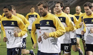 Australia's Tim Cahill left, and captain  Lucas Neill, center, lead the team in a warm up run during training at St Stithians College in Johannesburg, South Africa. AP Photo/Rob Griffith.