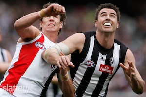 St Kilda's Justin Koschitzke and Collingwood's Darren Jolly contest the throw-in during the AFL Round 16 match between the Collingwood Magpies and the St Kilda Saints at the MCG, Melbourne.