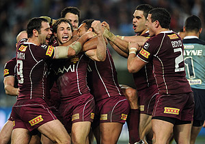 Queensland players celebrate a try by Billy Slater. AAP Image/Paul Miller