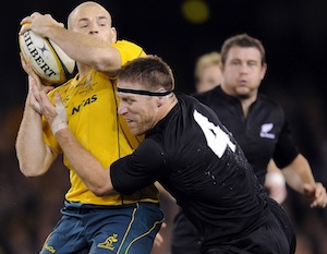 New Zealand All Blacks' player Brad Thorn, right lays a tackle on Australia's Stephen Moore.