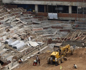 Laborers work at Shivaji stadium, one of the practice venues for the upcoming Commonwealth Games, in New Delhi, India, Tuesday, Aug. 17, 2010.