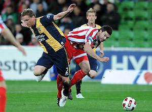 Melbourne Heart's Michel Beauchamp tackles Daniel McBreen from the Central Coast Mariners. AAP Image/ Joe Castro