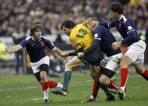 Australia's Adam Ashley-Cooper, center, is grabbed by France's Aurelien Rougerie, center right, Yannick Jauzion as Alexis Palisson looks on them during the international rugby match between France and Australia