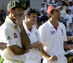 Australia's Ricky Ponting, left, rubs his chin as England's captain Andrew Strauss applauds teammate Alistair Cook. AP Photo/Rick Rycroft
