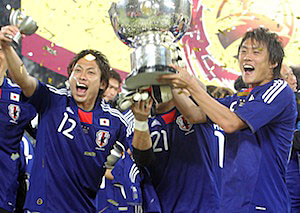 Japan team members celebrate with the AFC Asian Cup trophy after winning the final match against Australia 1-0 in Doha, Qatar.