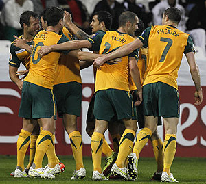 Australia players celebrate after fellow team member Mile Jedinak, unseen, scored against Bahrain. AP Photo/Hassan Amma