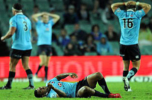 Waratahs Kurtley Beale lays on the field injured during their Super Rugby match against the Cheetahs at the SFS, Sydney