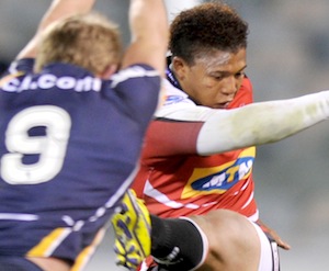 Lions Elton Jantjies clears the ball as Brumbies Josh Valentine runs in to block