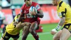 Will Genia of the Reds tries to break a Hurricanes tackle