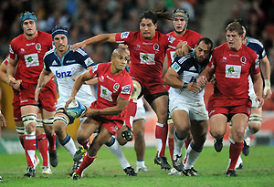 Queensland Reds half back Will Genia looks to offload during Super Rugby competition. AAP Image/Dave Hunt