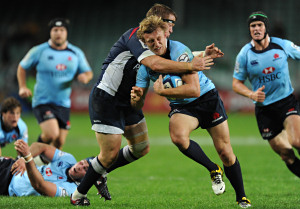 The Waratah's Lachie Turner is tackled by the Rebel's Greg Somerville during their Super Rugby match at the SFS, Sydney, April 30, 2011. (AAP Image/Dean Lewins)