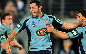 New South Wales Anthony Minichiello (centre) celebrates after scoring a try against Queensland during game 2 of the State of Origin Rugby League series in Sydney, Wednesday, June 15, 2011. Queensland lead the series with a win in game 1. (AAP Image/Dean Lewins)
