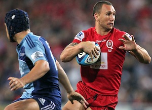 Quade Cooper of the Queensland Reds of Australia charges through of the Auckland Blues
