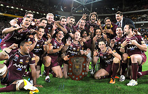 The Queensland team celebrate their win in State of Origin. AAP Image/Dave Hunt
