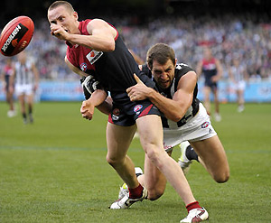 Travis Cloke of Collingwood tackles Tom Scully of Melbourne. AAP Image/Martin Philbey