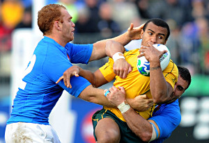 Wallabies player Will Genia is tackled during the Rugby World Cup Pool C match between the Australia and Italy at North Harbour Stadium in Auckland, New Zealand, Sunday, Sept. 11, 2011. (AAP Image/Dave Hunt)