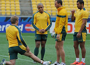 Wallabies Will Genia (2nd-L), speaks with teammates Drew Mitchell (L), Quade Cooper (2nd-R) and Kurtley Beale. AFP PHOTO / Greg WOOD