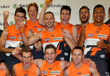 GWS Giants celebrate their first AFL win in the changerooms